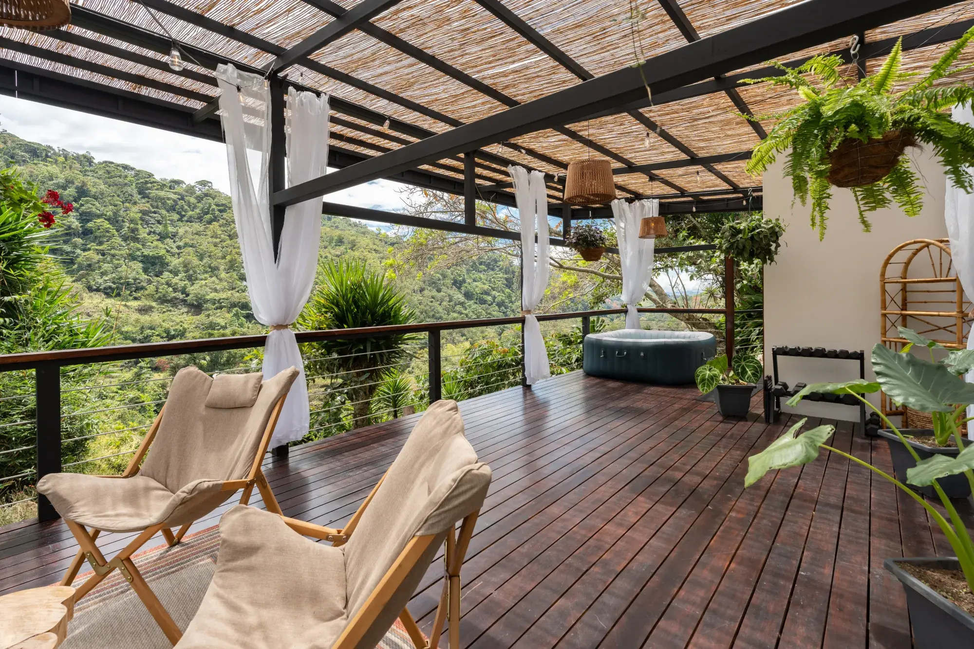 Covered yoga deck with hot tub and mountain views at the Costa Rica retreat estate